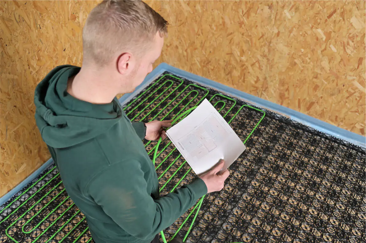 The installer is looking over the heating plan.
