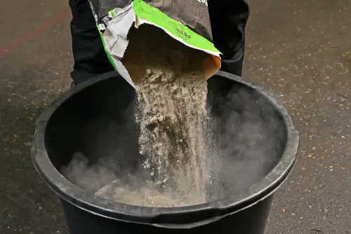 The installer is mixing up the compound and getting ready for pouring.