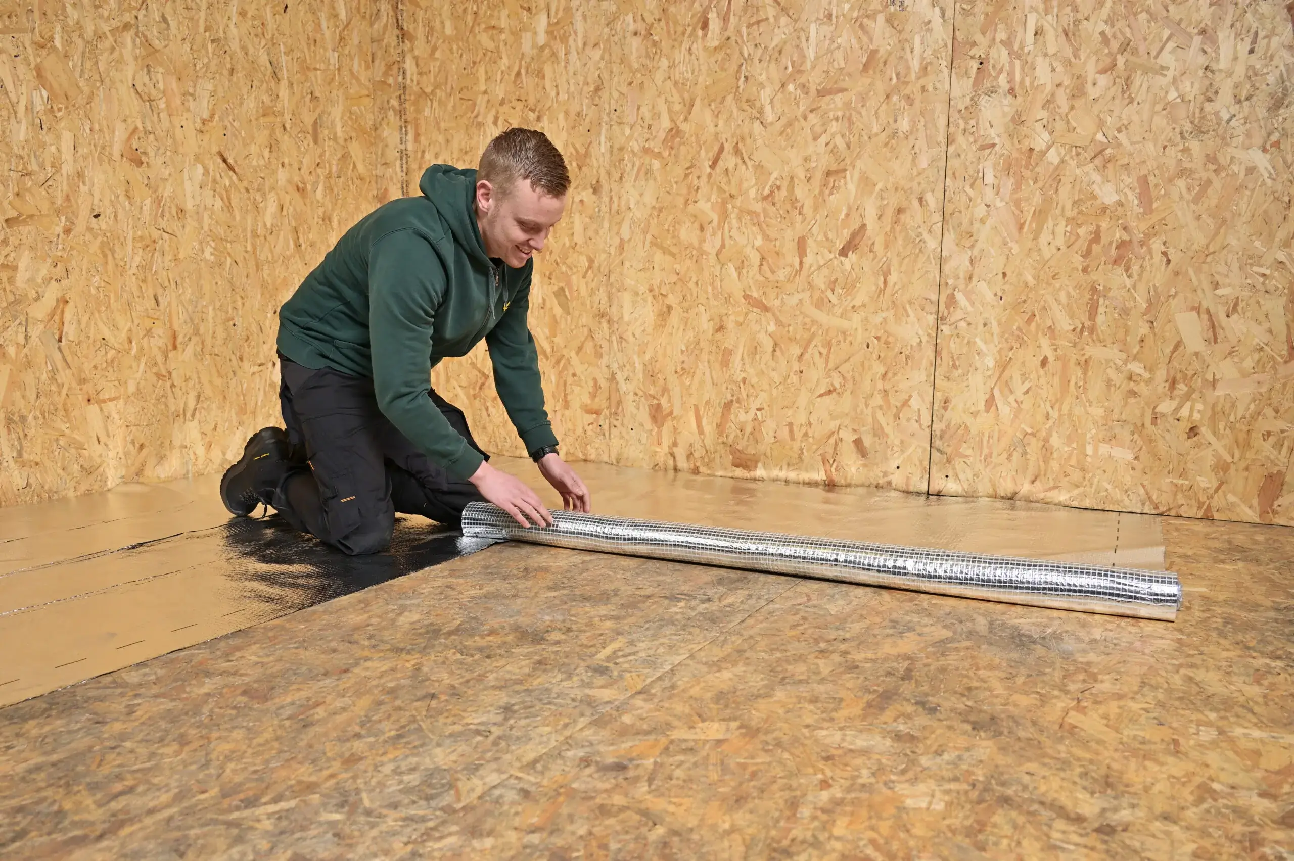 A installer laying down aluminum reflection foil.
